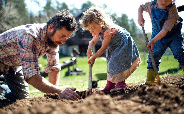Herz in Form: Vater und Kleinkinder bei der Gartenarbeit