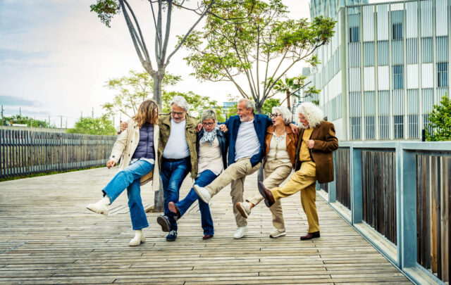 Healthy Longevity2: Happy group of senior people having fun walking outdoors